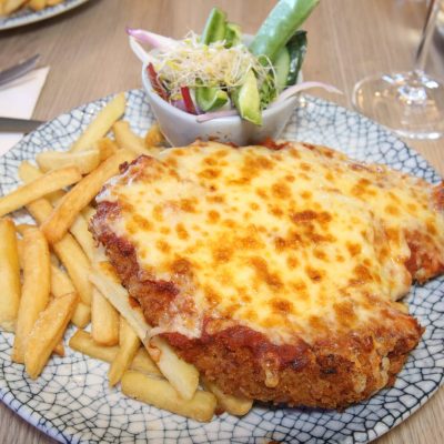 Chicken Parmigiana served with chips and salad